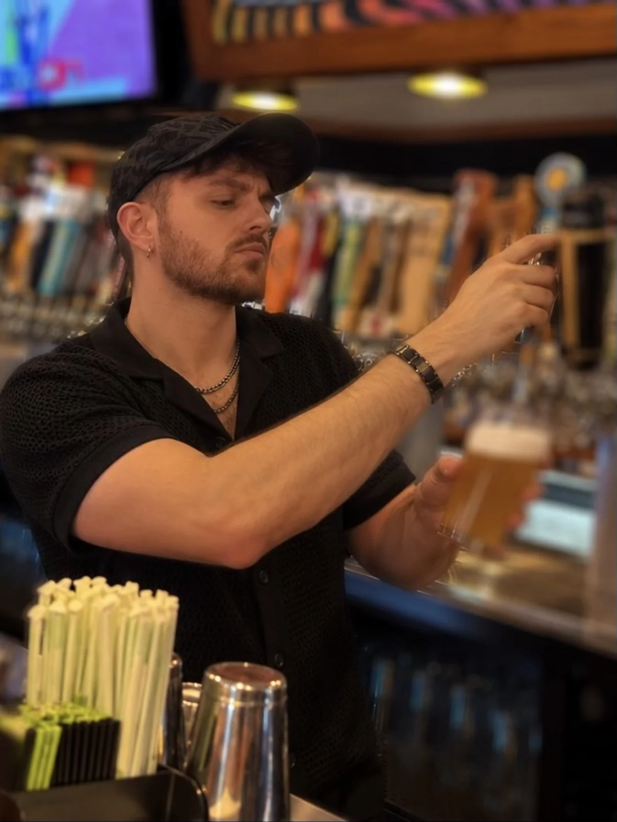 Cody McKenzie behind the bar beside the beer taps