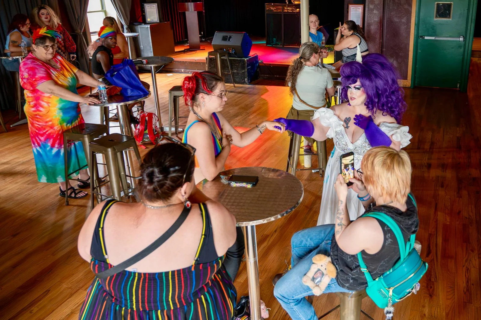 Guests seated and standing around tables at The Crofoot